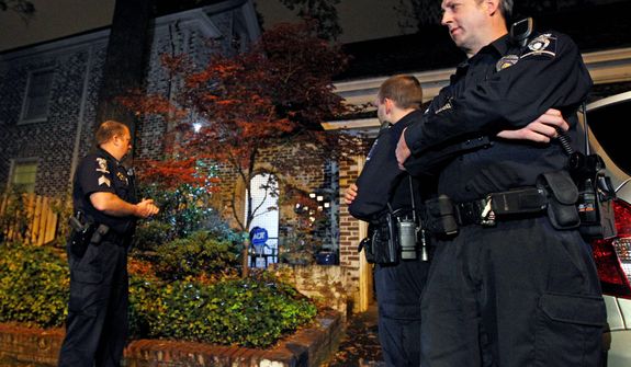 Charlotte-Mecklenburg police stand guard outside the home of Paula Broadwell, the woman whose affair with retired Gen. David Petraeus led to his resignation as CIA director, in the Dilworth neighborhood of Charlotte, N.C., on Nov. 13, 2012. (Associated Press)