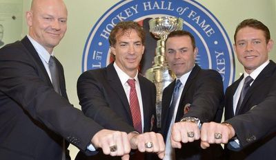 Hockey Hall of Fame inductees, from left, Mats Sundin, of Sweden, Joe Sakic, Adam Oates and Pavel Bure, of Russia,  pose for a photograph with their rings at the Hockey Hall of Fame in Toronto, Monday, Nov. 12, 2012. (AP Photo/The Canadian Press, Nathan Denette)