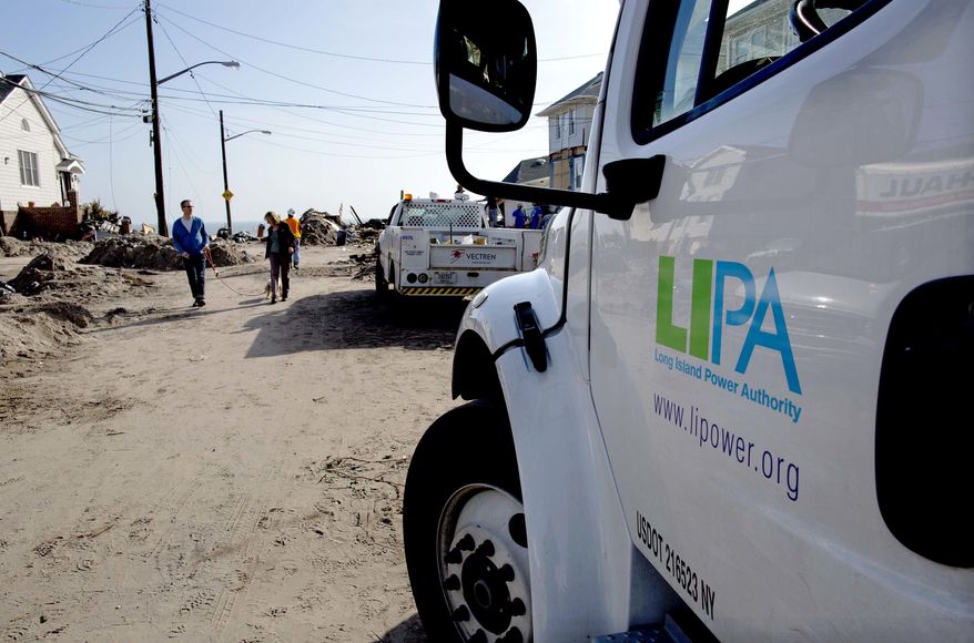 A Long Island Power Authority (LIPA) truck is seen in the Belle Harbor neighborhood of the borough of Queens, New York, Monday, Nov. 12, 2012, in the wake of Superstorm Sandy. More than 70,000 customers of Long Island Power Authority in New York were without electricity Monday, two weeks after Superstorm Sandy struck. (AP Photo/Craig Ruttle)

