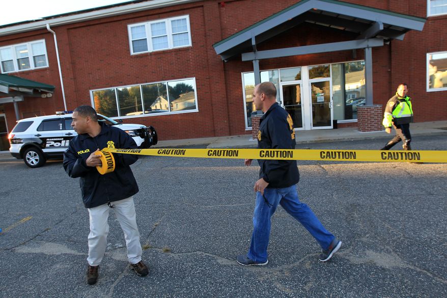 **FILE** Federal agents investigate the offices of New England Compounding Center in Framingham, Mass., on Oct. 16, 2012. The company's steroid medication has been linked to a deadly meningitis outbreak. (Associated Press/The Boston Globe, Barry Chin)