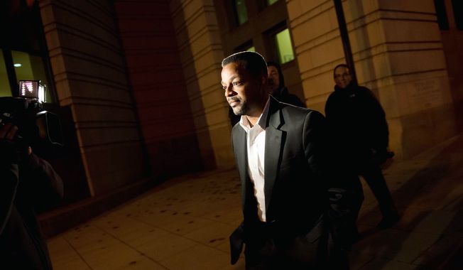 Former D.C. Council Chairman Kwame Brown leaves federal court in Washington on Tuesday after being sentenced to one day in custody and six months of home detention for lying on loan applications. (Andrew Harnik/The Washington Times)