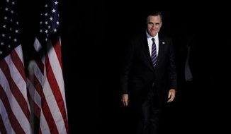 **FILE** Republican presidential candidate Mitt Romney emerges Nov. 7, 2012, from backstage to concede his quest for President of the United States at his election night event at the Boston Convention Center in Boston. (Associated Press)