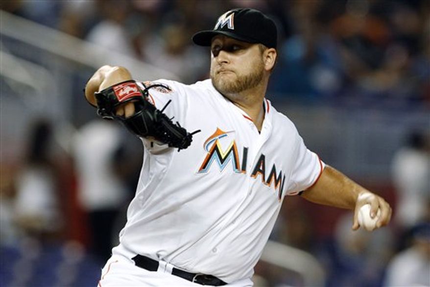 ** FILE ** In this May 26, 2012 photo, Miami Marlins starting pitcher Mark Buehrle throws in the first inning of a baseball game against the San Francisco Giants in Miami. A person familiar with the deal told The Associated Press on condition of anonymity Tuesday, Nov. 13, that the Marlins have traded Buehrle to the Toronto Blue Jays. (AP Photo/Lynne Sladky)