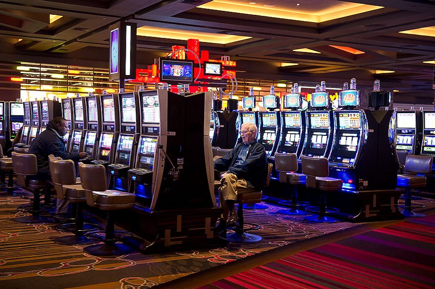 People play slot machines at Maryland Live! Casino in Hanover, Md. on Wednesday, Nov. 14, 2012. The casino held a press conference Wednesday to announce that it plans to add live game tables and 24-hour gambling as soon as possible after the state issues the necessary governing regulations. They hope to have the 150 new table games in place by spring. (Barbara L. Salisbury/The Washington Times)