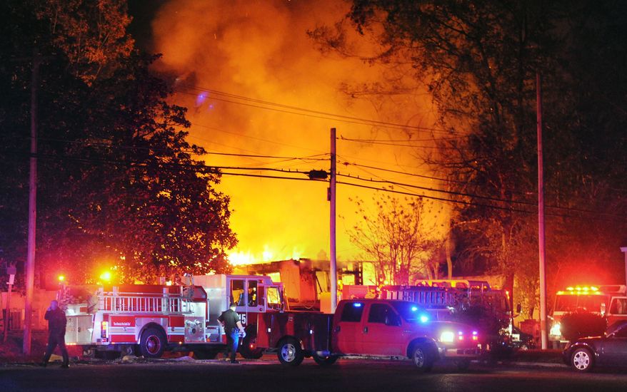 Flames and smoke billow from a home in west Jackson, Miss., Tuesday evening, Nov. 13, 2012, after authorities say a small plane carrying three people crashed into the residence shortly after 5 p.m. (AP Photo/The Clarion-Ledger, Joe Ellis)