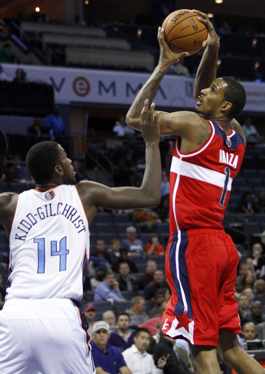 Washington Wizards' Trevor Ariza (1) shoots over Charlotte Bobcats' Michael Kidd-Gilchrist (14) during the second half of an NBA basketball game in Charlotte, N.C., Tuesday, Nov. 13, 2012. Charlotte won 92-76. (AP Photo/Chuck Burton)