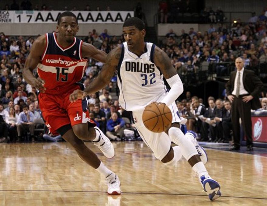 Dallas Mavericks&#39; O.J. Mayo (32) gets by Washington Wizards&#39; Jordan Crawford (15) on a charge to the basket in the second half of an NBA game, Wednesday, Nov. 14, 2012, in Dallas. Mayo led all scoring with 25 points in the 107-101 Mavericks win. (AP Photo/Tony Gutierrez)