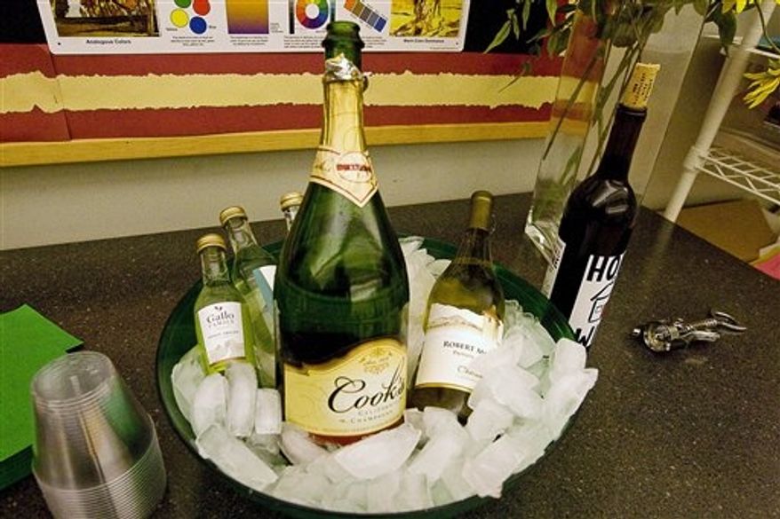 In this Oct. 18, 2012, photo, bottles of wine are seen on hand at the Decatur Area Arts Council in Decatur, Ill., for the new series called "Cocktails and Creations" that encourages adult participants to bring drinks to class. The program combines the elements of food and drink with creating a piece of art in a relaxed atmosphere. (AP Photo/Herald & Review, Lisa Morrison)