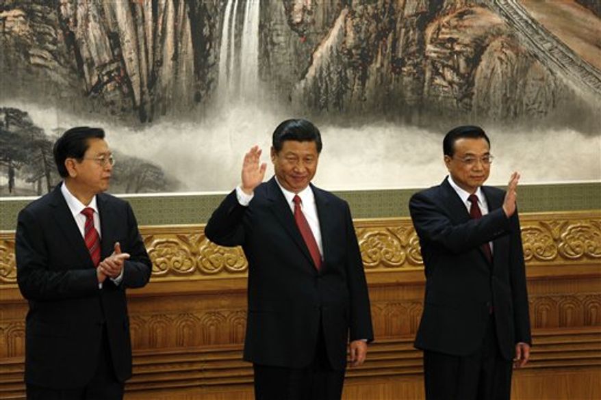 From left, members of the new Politburo Standing Committee Zhang Dejiang, Xi Jinping, Li Keqiang meet journalists in Beijing's Great Hall of the People Thursday, Nov. 15, 2012. The seven-member Standing Committee, the inner circle of Chinese political power, was paraded in front of assembled media on the first day following the end of the 18th Communist Party Congress. (AP Photo/Vincent Yu)