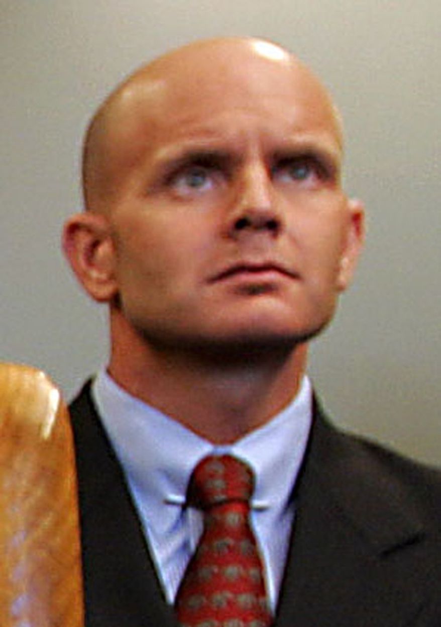 In this July 27, 2005, photo, FBI Agent Frederick Humphries listens during a news conference after the sentencing of Ahmed Ressam at the Federal Courthouse in Seattle. Humphries has been identified as the agent socialite Jill Kelley contacted to complain about harassing emails sent by Gen. David Petraeus' paramour, Paula Broadwell. (AP Photo/Kevin P. Casey)