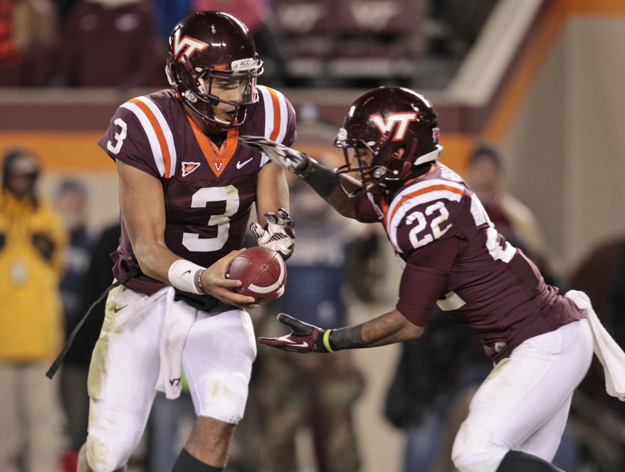 Virginia Tech quarterback Logan Thomas (3) hands the ball off to Virginia Tech running back Tony Gregory (22) during the second half of a NCAA college football game in Blacksburg, Va., Thursday, Nov. 8, 2012. Florida State won the game 22-28. (AP Photo/Steve Helber)