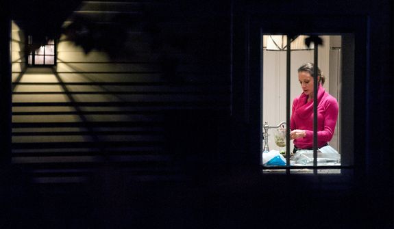 Paula Broadwell is visible through the window in the kitchen of her brother&#39;s house in Washington, Tuesday, Nov. 13, 2012. Broadwell is CIA Director David Petraeus&#39; biographer, with whom he had an affair that led to his abrupt resignation last Friday. It was Broadwell&#39;s threatening emails to Jill Kelley, a Florida woman who is a Petraeus family friend, that led to the FBI&#39;s discovery of communications between Broadwell and Petraeus indicating they were having an affair. (AP Photo/Cliff Owen)