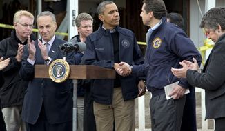 President Obama shakes hands with New York Gov. Andrew Cuomo, during a news conference on Cedar Grove Avenue, a street significantly impacted by Superstorm Sandy, on Staten Island, Thursday, Nov. 15, 2012, in New York. Sen. Charles Schumer, New York Democrat, is second from left, Secretary of Housing and Urban Development Shaun Donovan is third from left, and Secretary of Homeland Security Janet Napolitano is right. (AP Photo/Carolyn Kaster)