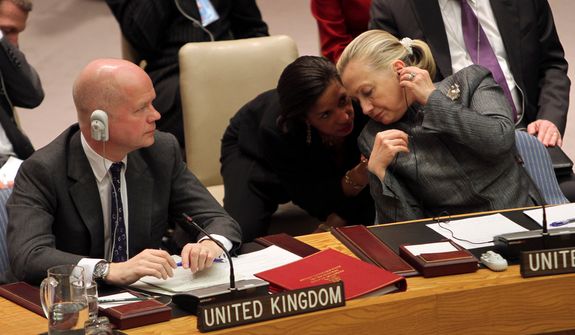 **FILE** United States Secretary of State Hillary Rodham Clinton (right) speaks Jan. 31, 2012, to Susan Rice, U.S. Ambassador to the United Nations, at United Nations headquarters as British Foreign Secretary William Hague listens to Syrian Ambassador to the United Nations Bashar Ja&#x27;afari address to a Security Council meeting on the situation in Syria. (Associated Press)