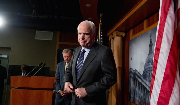 Republican Sens. John McCain (right) of Arizona and Lindsey Graham of South Carolina leave after holding a press conference at the U.S. Capitol on Nov. 14, 2012. The senators called for a hearing on the Benghazi attack. (Andrew Harnik/The Washington Times)