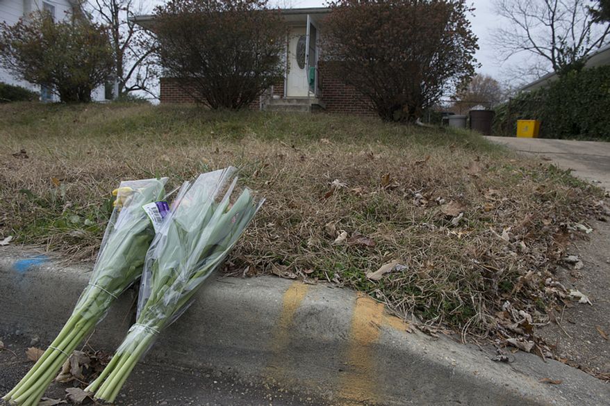 Flowers have been placed outside a house in Riverdale on Thursday, Nov. 15, 2012 where a man was fatally shot Wednesday night by a Prince George's County sheriff's deputy who was attempting to serve a peace order. The man allegedly brandished some sort of weapon, which turned out to be a replica. (Barbara L. Salisbury/The Washington Times)