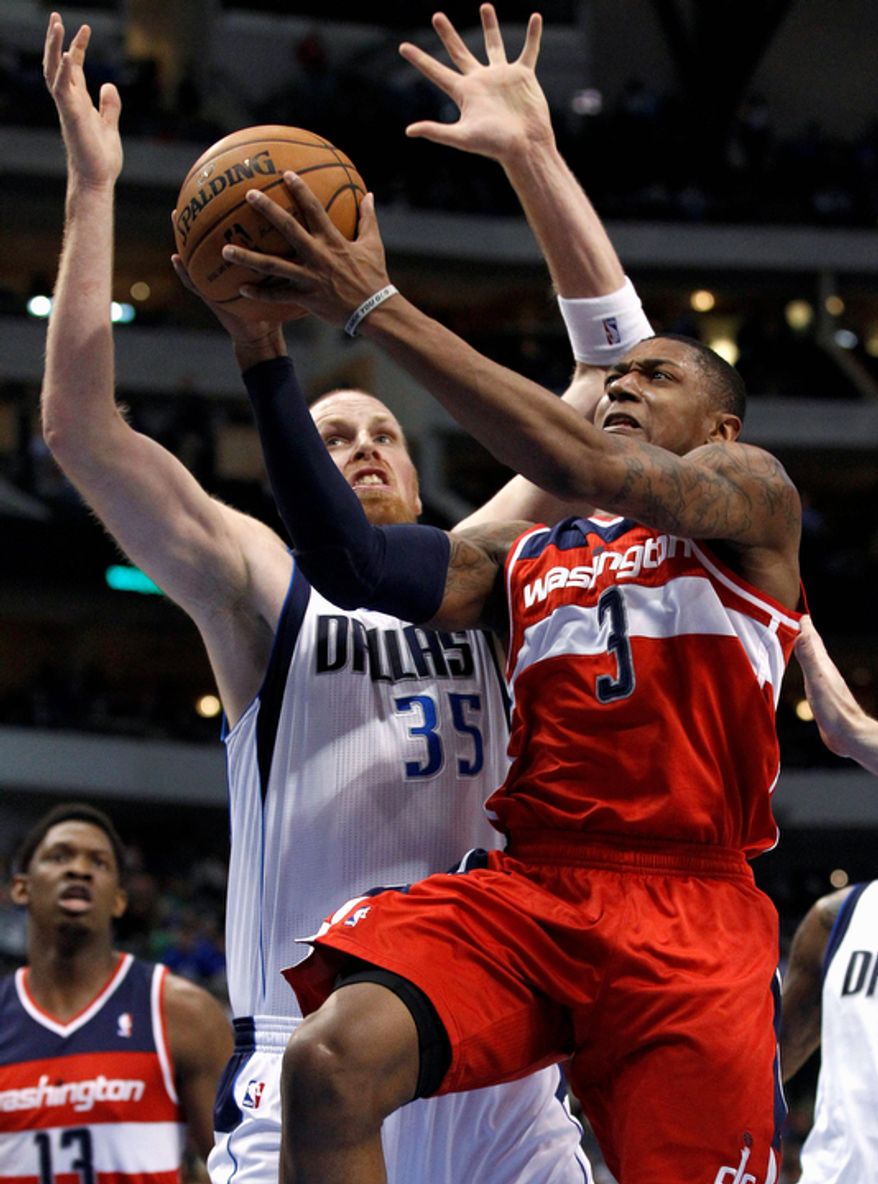 Washington Wizards&#39; Bradley Beal (3) attempts a shot after getting by Dallas Mavericks&#39; Chris Kaman (35) in the first half of an NBA basketball game, Wednesday, Nov. 14, 2012, in Dallas. (AP Photo/Tony Gutierrez)