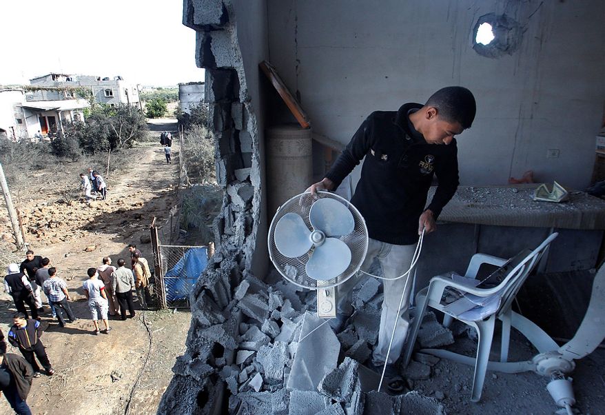 A Palestinian man inspects the damage to a mosque after an Israeli airstrike in Beit Hanoun, north Gaza, Friday, Nov. 16, 2012. Israel offered to suspend its offensive in the Gaza Strip on Friday during a brief visit by Egypt's premier there if militants refrain from firing rockets at Israel, an official said, but the Palestinians unleashed a fresh salvo. (AP Photo/Hatem Moussa)