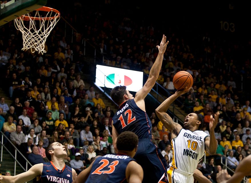 George Mason Patriots guard Sherrod Wright (10) is fouled while attempting a lay up in the first half against the Virginia Cavaliers at the Patriot Center in Fairfax, Va., Wednesday, November 9, 2012. George Mason Patriots host the Virginia Cavaliers for the 2012-2013 men's college basketball season opener. (Craig Bisacre/The Washington Times)