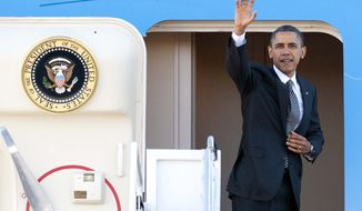 President Barack Obama waves as he boards Air Force One at Andrews Air Force Base, Md., Saturday, Nov. 17, 2012, en route to Southeast Asia. (AP Photo/Cliff Owen)