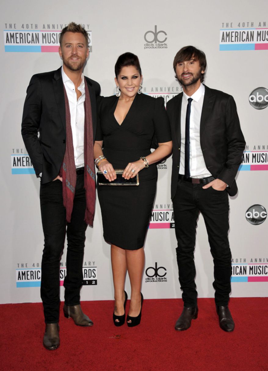 Charles Kelley, left, Hillary Scott, center, and Dave Haywood from the band Lady Antebellum arrive at the 40th Anniversary American Music Awards on Sunday, Nov. 18, 2012, in Los Angeles. (Photo by John Shearer/Invision/AP)