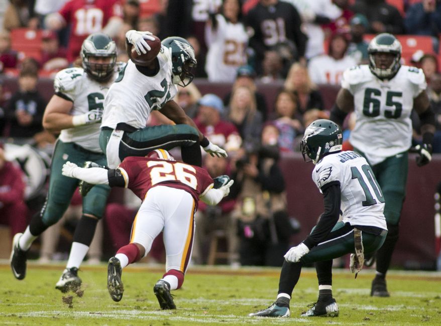 Washington Redskins cornerback Josh Wilson (26) dives for Philadelphia Eagles running back LeSean McCoy (25) in the second half, Landover, Md., Sunday, November 18, 2012. (Craig Bisacre/The Washington Times)