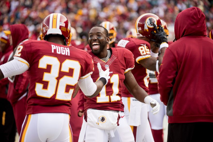 Washington Redskins wide receiver Aldrick Robinson (11), center, celebrates on the sideline after catching a 49 yard touchdown pass in the second quarter as the Washington Redskins play the Philadelphia Eagles at FedEx Field, Landover, Md., Sunday, Nov. 18, 2012. (Andrew Harnik/The Washington Times)