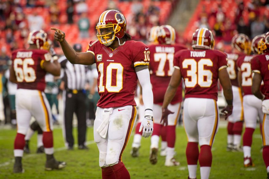 Washington Redskins quarterback Robert Griffin III (10) smiles and points to the sideline as the offense takes the field to run out the clock at the end of the fourth quarter as the Washington Redskins defeat the Philadelphia Eagles 31-6 at FedEx Field, Landover, Md., Sunday, Nov. 18, 2012. (Andrew Harnik/The Washington Times)
