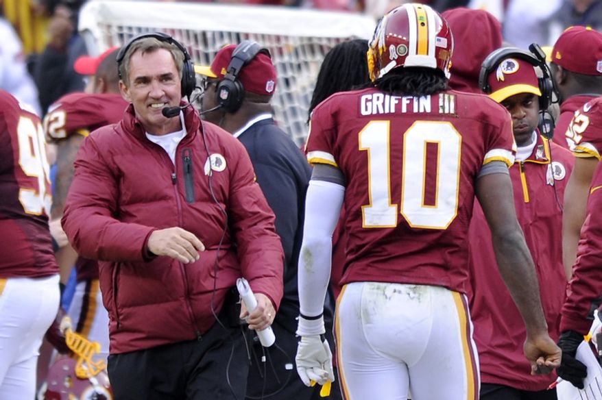 Washington Redskins head coach Mike Shanahan is all smiles as quarterback Robert Griffin III (10) comes to the bench following his 61-yard touchdown pass in the third quarter at FedEx Field, Landover, Md., Nov. 18, 2012. (Preston Keres/Special to The Washington Times)