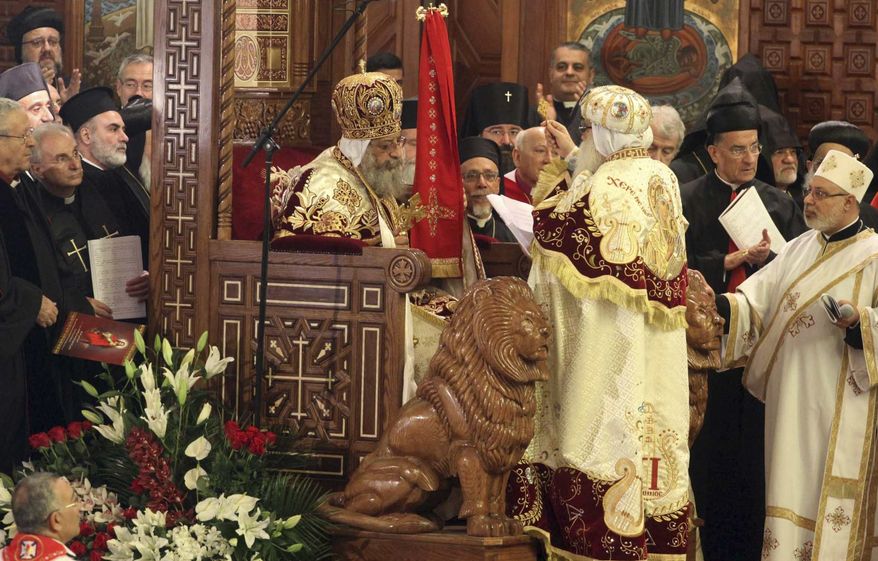 ** FILE ** Pope Tawadros II, 60, sits on the throne of St. Mark, the Coptic Church's founding saint, wearing the papal crown, during an elaborate ceremony lasting nearly four hours and attended by the nation's Muslim prime minister and a host of Cabinet ministers and politicians, in the Coptic Cathedral in Cairo on Sunday, Nov. 18, 2012. (AP Photo/Sami Wahib)
