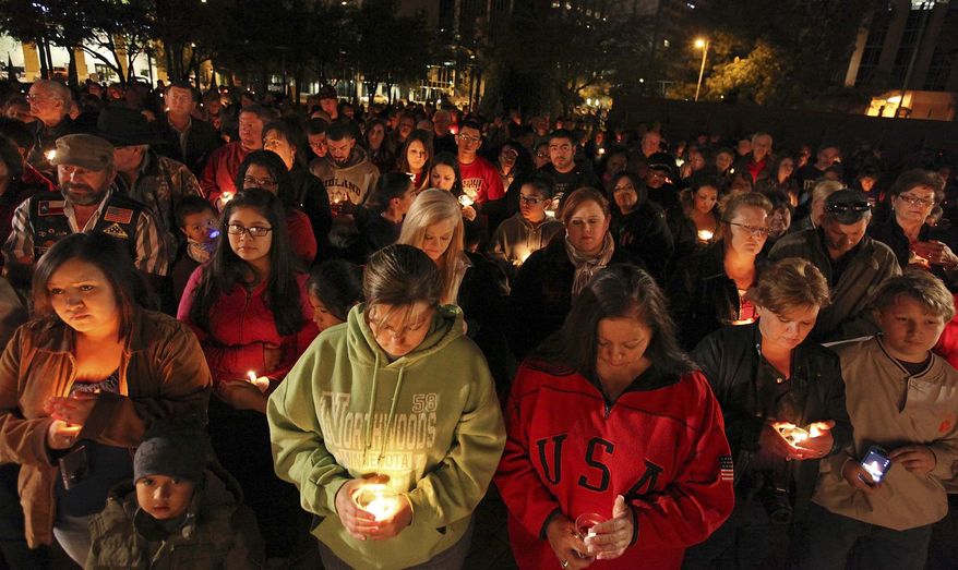 About 200 people attend a candlelight vigil held at Centennial Plaza in Midland, Texas on Saturday, Nov. 17, 2012, in honor of the people involved in an accident where a Union Pacific train struck a float carrying military veterans on Thursday Nov. 15, 2012. Four veterans were killed, including one from the San Antonio area. (AP Photo/San Antonio Express-News, Edward A. Ornelas)