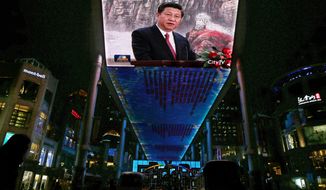 **FILE** A huge screen shows a broadcast of China&#39;s new Communist Party General Secretary Xi Jinping speaking in Beijing&#39;s Great Hall of the People on Nov. 15, 2012. (Associated Press)