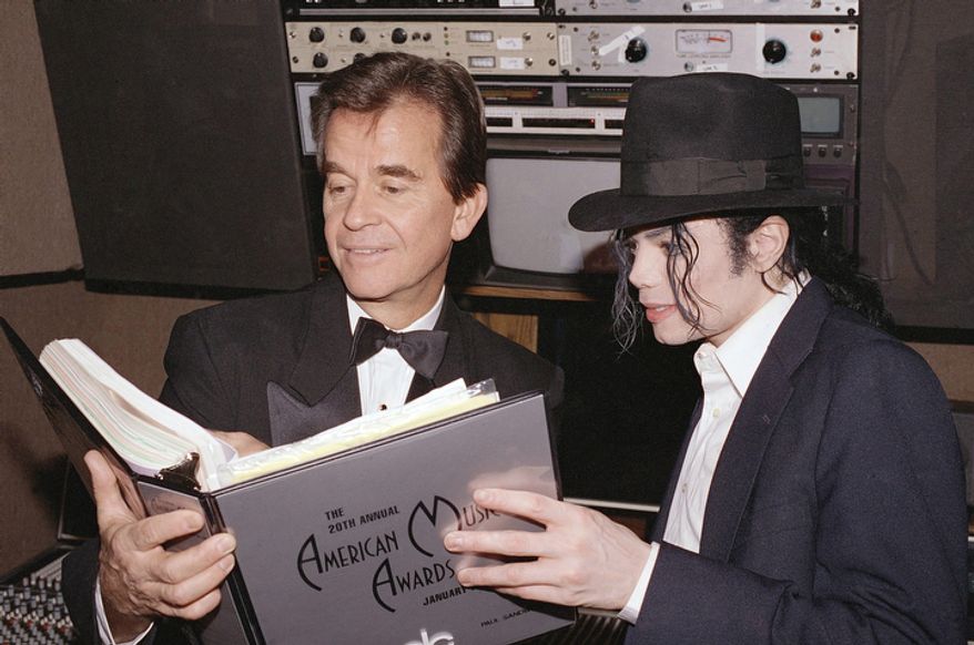 **FILE** Michael Jackson and Dick Clark go over the script during rehearsals for the American Music Awards at the Shrine Auditorium in Los Angeles on Jan. 24, 1993. (Associated Press)