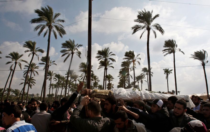 Palestinian mourners carry the body of farmer Amin Bashir, 40, during his funeral in Deir Al Balah, central Gaza Strip, Monday, Nov. 19, 2012. The Palestinian civilian death toll mounted Monday as Israeli aircraft struck densely populated areas in the Gaza Strip in its campaign to quell militant rocket fire menacing nearly half of Israel's population. (AP Photo/Adel Hana)