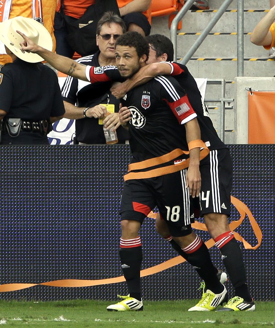 D.C. United's Nick DeLeon (18) celebrates his goal with Lewis Neal, right, during the first half of an MLS Eastern Conference Championship soccer game against the Houston Dynamo, Sunday, Nov. 11, 2012, in Houston. (AP Photo/David J. Phillip)