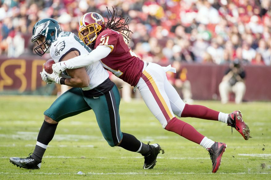 Philadelphia Eagles tight end Clay Harbor (82) is tacked by Washington Redskins defensive back Brandon Meriweather (31) in the second quarter as the Washington Redskins play the Philadelphia Eagles at FedEx Field, Landover, Md., Sunday, Nov. 18, 2012. (Andrew Harnik/The Washington Times)