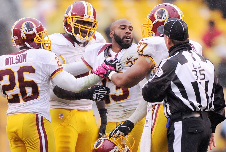 Washington Redskins cornerback DeAngelo Hall (23) is held back by teammates as he argues with the line judge John Hussey at Heinz Field, Pittsburgh, Pa., Oct. 28, 2012. (Preston Keres/Special to The Washington Times)