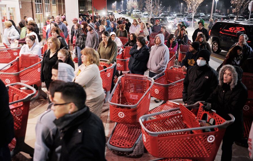 ** FILE ** Crowds of shoppers were ready to storm stores across the country last year as Black Friday began at the stroke of midnight. (Associated Press)