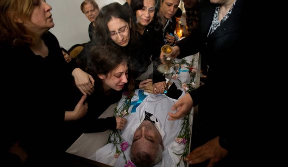 Palestinians mourners cry during the funeral of Salem Paul Sweliem in Gaza City on Nov. 20, 2012. According to the family, the 52-year-old Greek Orthodox Christian carpenter was killed during an Israel Air Force strike on a high-rise building, in which Ramez Harb, a senior figure in Islamic Jihad&#39;s military wing, was killed. Sweliem was in car when the strike took place and died on his way to the hospital from shrapnel wounds. (Associated Press)