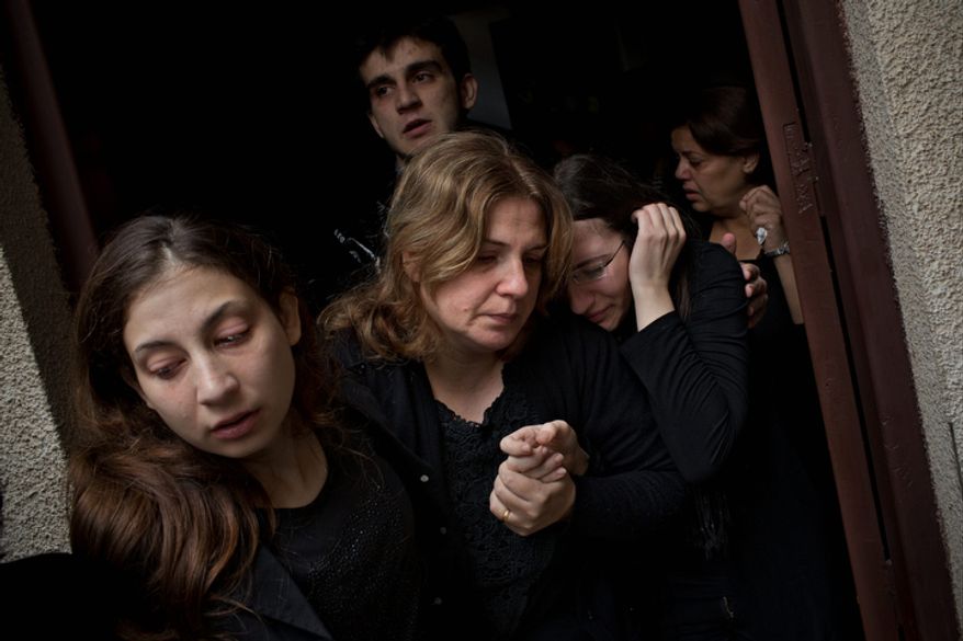 Palestinians mourners cry during the funeral of Salem Paul Sweliem in Gaza City on Nov. 20, 2012. According to the family, the 52-year-old Greek Orthodox Christian carpenter was killed during an Israel Air Force strike on a high-rise building, in which Ramez Harb, a senior figure in Islamic Jihad's military wing, was killed. Sweliem was in car when the strike took place and died on his way to the hospital from shrapnel wounds. (Associated Press)