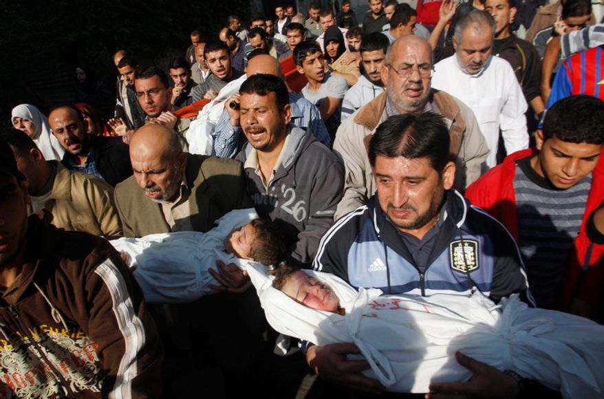 Palestinian mourners carry the bodies of Foud Hijazi, 45, and his sons Suhaib, 2, and Mohammed, 4, all of whom were killed in an Israeli strike, during their funeral in the Jebaliya refugee camp in Gaza Strip on Nov. 20, 2012. (Associated Press)