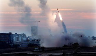 **FILE** The Iron Dome defense system fires to intercept incoming missiles from Gaza in the port town of Ashdod on Nov. 15, 2012. (Associated Press)