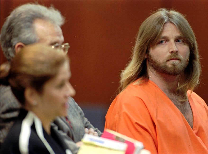 **FILE** Convicted murderer Glen Rogers (right) stares at public defender Joan Corces during a July 8, 1996, hearing in Tampa, Fla. (Associated Press)