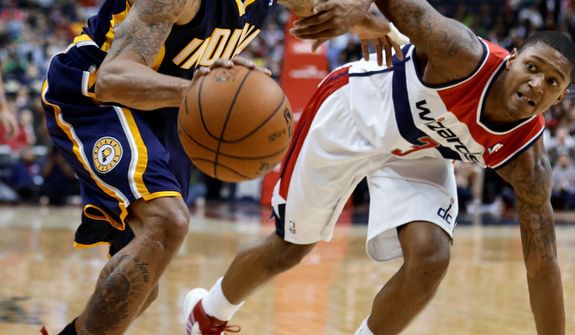 Indiana Pacers guard George Hill tries to get past Washington Wizards guard Bradley Beal during the second half of the Pacers&#39; 96-89 road win on Nov. 19, 2012. (Associated Press)
