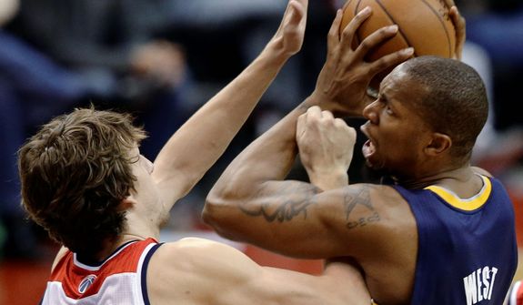Indiana Pacers forward David West gets tangled up with Washington Wizards forward Jan Vesely during the second half of the Pacers&#39; 96-89 road win on Nov. 19, 2012. (Associated Press)