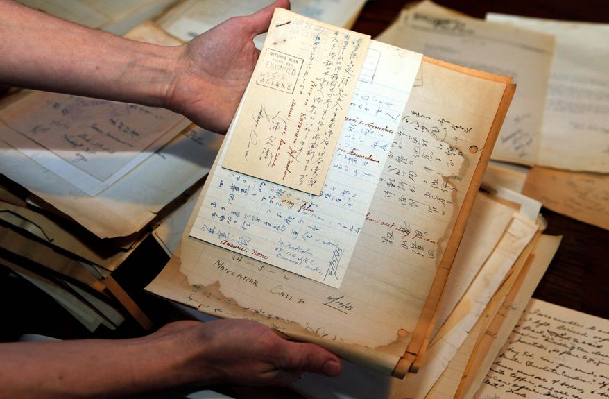 Alissa Williams of Denver holds letters addressed to T.K. Pharmacy in the early 1940s found during renovations at a former Denver pharmacy owned by Japanese-Americans. Some of the letters arriving from Japanese-American internment camps during World War II asked for cough drop of bath powder; others were just desperate for anything from the outside world. (Associated Press)