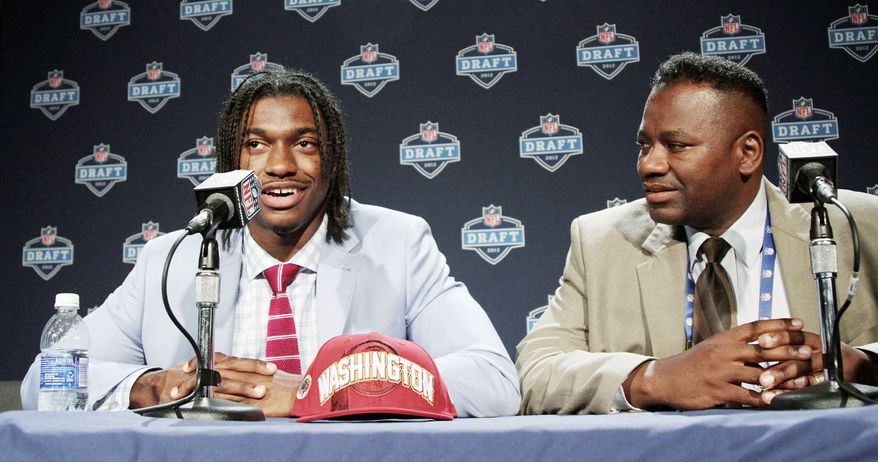 Robert Griffin III was joined by his father, Robert Griffin Jr., as he addressed members of the media after being drafted by the Redskins. Robert Jr. and wife Jacqueline instilled principles rooted in faith and family, which Robert III has carried with him into his NFL career. (Associated Press)