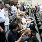 Protesters remain seated during an opening prayer at a Hamilton County Commission meeting in Chattanooga, Tenn. At least five lawsuits around the country — in California, Florida, Missouri, New York, and Tennessee — are challenging pre-meeting prayers. Lawyers in a New York case plan to ask the Supreme Court to revisit the issue. (Associated Press)