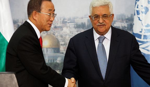 Palestinian President Mahmoud Abbas, right, and United Nations Secretary-General Ban Ki-moon, left, shake hands for photographers following a joint press conference in the West bank city of Ramallah, Wednesday, Nov. 21, 2012. World diplomats continued shuttling between Jerusalem, the West Bank and Cairo on Wednesday, trying to piece together a deal that would satisfy Israeli after a week of fighting and mounting casualties.(AP Photo/Majdi Mohammed)