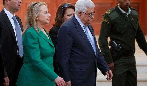 U.S. Secretary of State Hillary Rodham Clinton, left, and Palestinian President Mahmoud Abbas walk together following a meeting in the West Bank city of Ramallah, Wednesday, Nov. 21, 2012. Clinton will try on Wednesday to wring an elusive truce deal from Israel and Gaza&#39;s militant Hamas rulers after earlier efforts to end more than a week of fighting broke down amid a furious spasm of violence. (AP Photo/Majdi Mohammed)